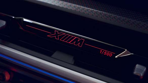 BMW XM LABEL RED IN FROZEN CARBON BLACK.