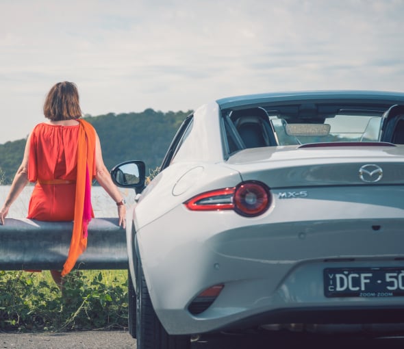 Nikki Gemmell salutes the sun in the MX-5